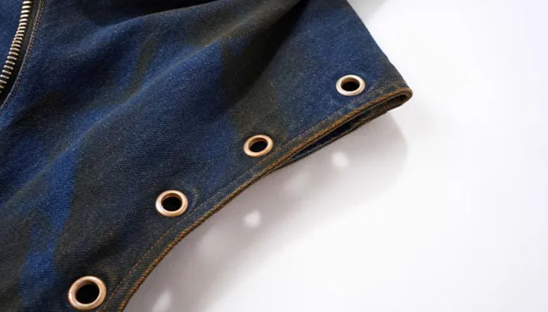 Blue hooded denim vest coat with front zip worn with matching trousers in a two-piece set.