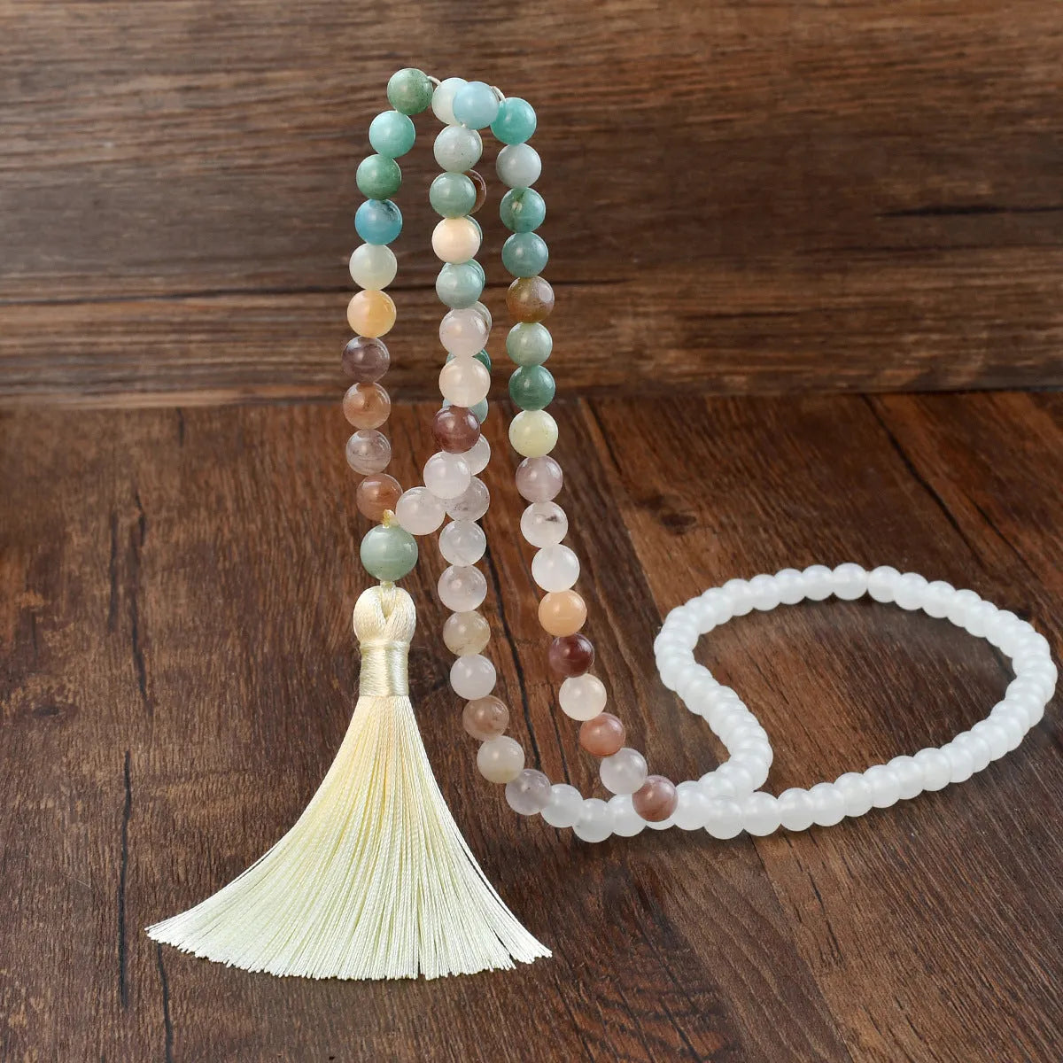 Long beaded necklace with geometric pendant and natural stone tassels in green aventurine.