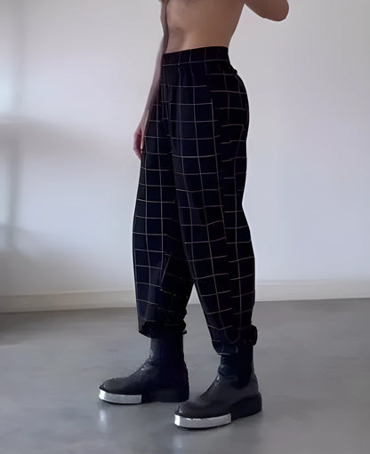 Men's plaid trousers with an apron-style front panel and elastic waistband
