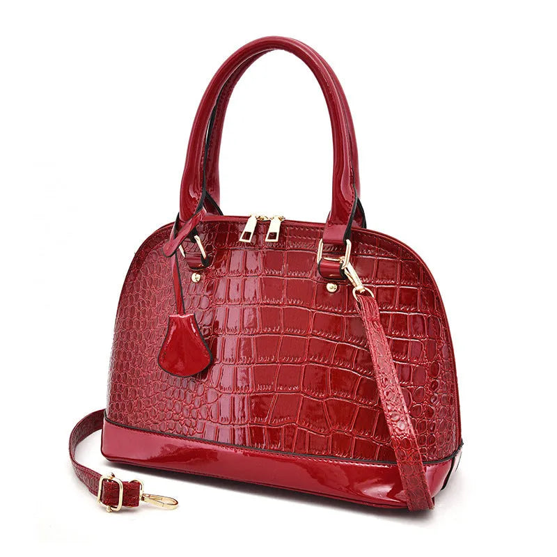 Large capacity shiny shoulder bag crossbody bag made from PU leather with a shell-shaped suitcase design measuring 22cm wide by 30cm high by 15cm deep, available in black, red, and brown colours with a polyester lining.