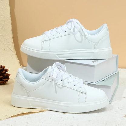 Beige brown women's low-top platform casual sneakers with a cross strap and round toe on a white background.