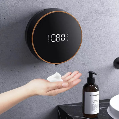 Black smart auto sensing foam dispenser mounted on a wall with USB charging cable, showing infrared sensor and foam output
