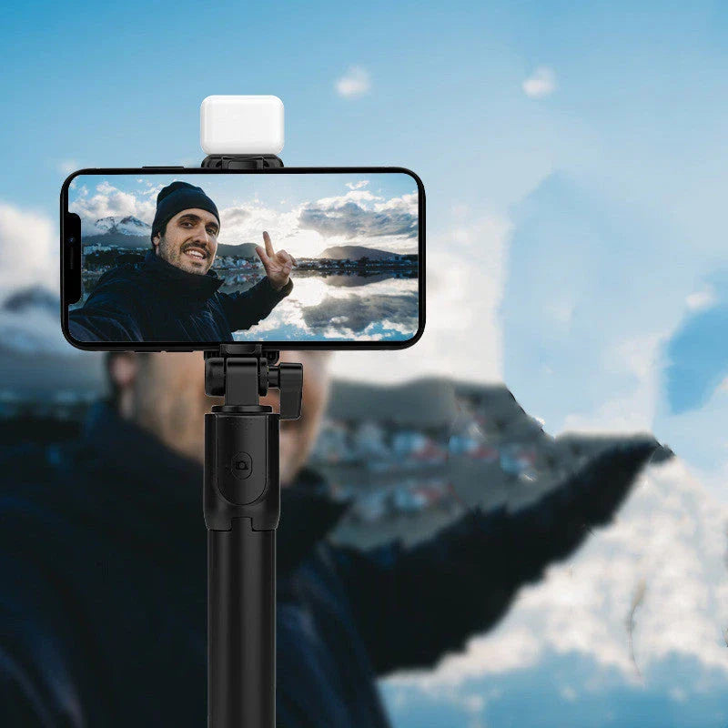 Bluetooth-enabled selfie stick with 360-degree rotation, integrated fill light, and Bluetooth remote control for versatile content creation on iPhone