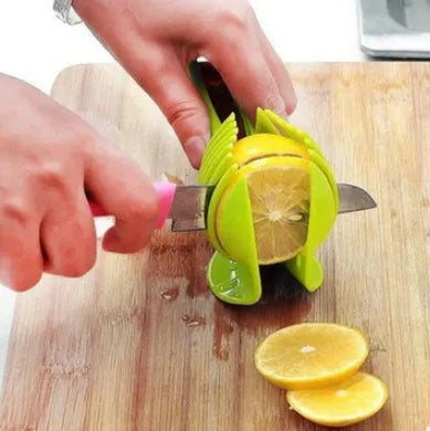 Plastic fruit and vegetable cutting holder slicer in black or green, measuring 18.5cm by 8cm