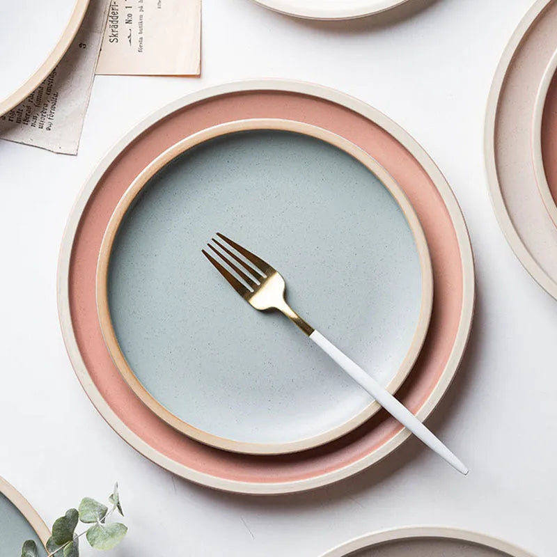 A blue matte-finish 10-inch ceramic dinner plate on a plain surface.