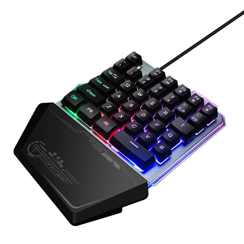 Black one-handed keyboard with RGB backlight and 1.8-metre USB cable on a desk
