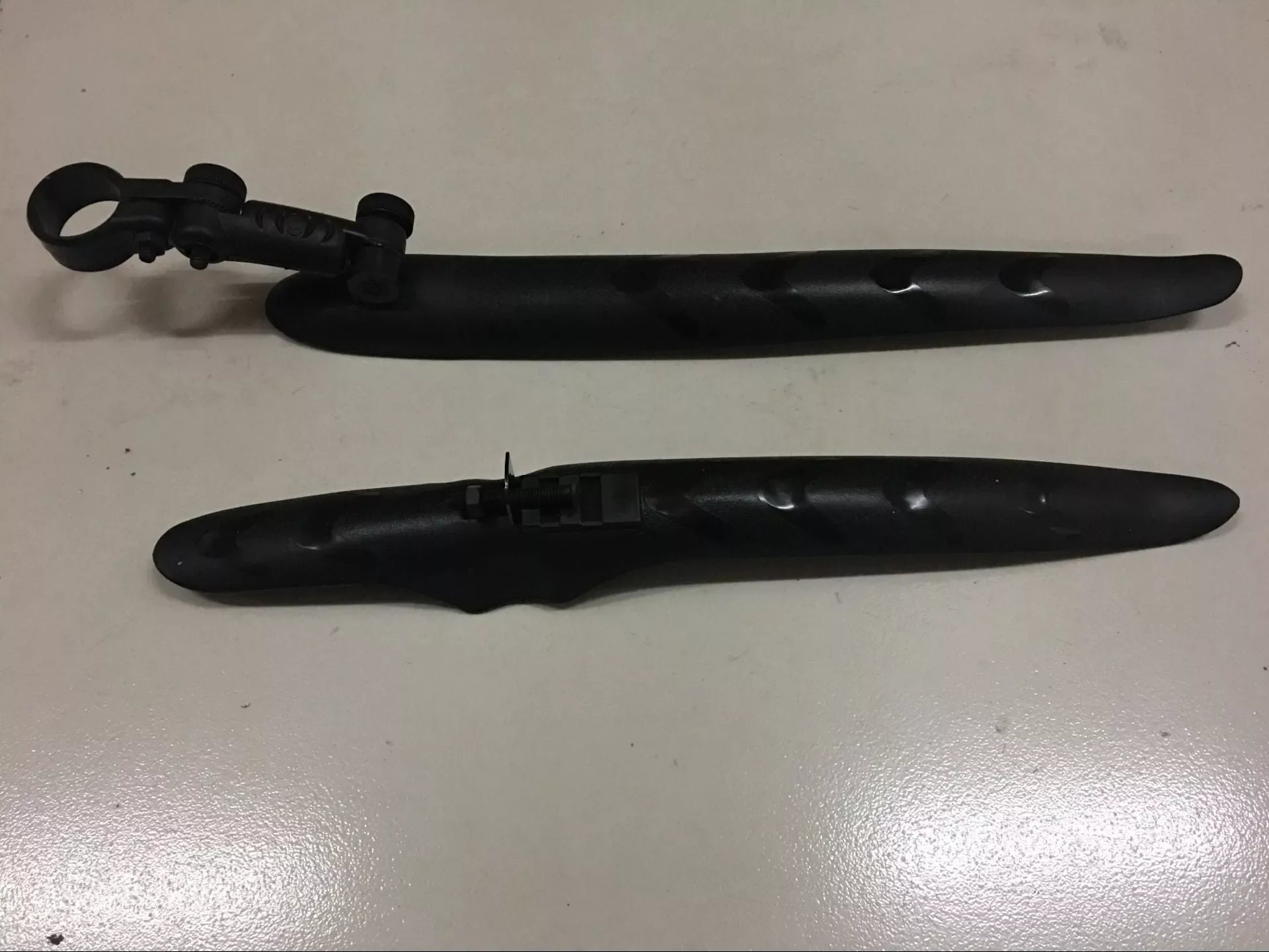 Road bike mudguard with durable plastic construction, perfect fit for clean rides