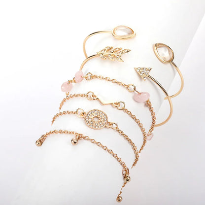 Set of six gold-colour zinc alloy bracelets with water drop, arrow, and V-shaped charms.