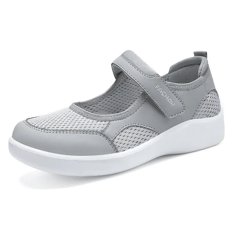 Women's grey velcro casual shoes with mesh upper and flat sole.