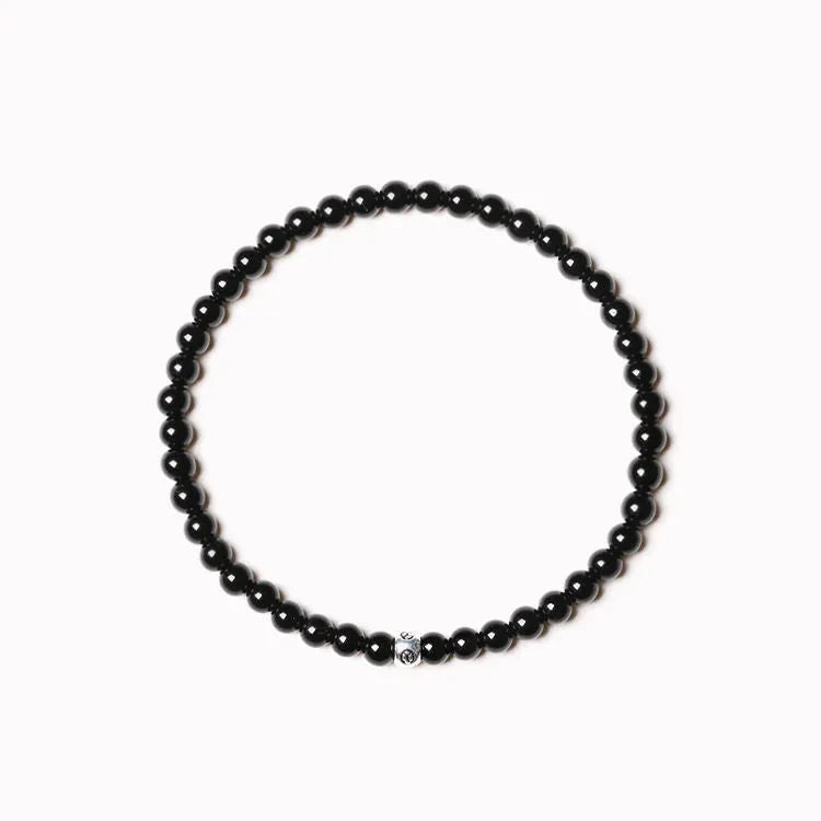 Geometric unisex bracelet with small Obsidian, blue San, and textured black agate beads.