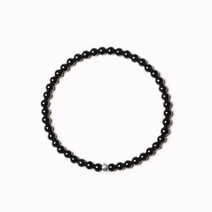 Geometric unisex bracelet with small Obsidian, blue San, and textured black agate beads.