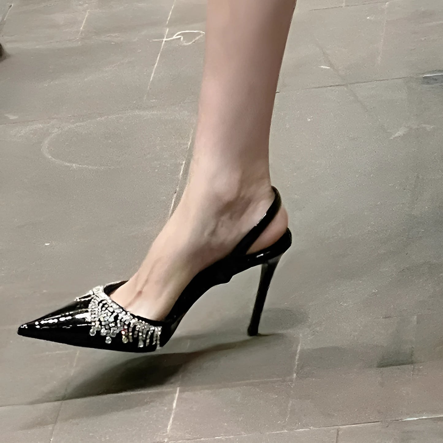 Black women's slingback high heel sandals with pointed toe, 10cm heel, and French tassel rhinestone decoration.