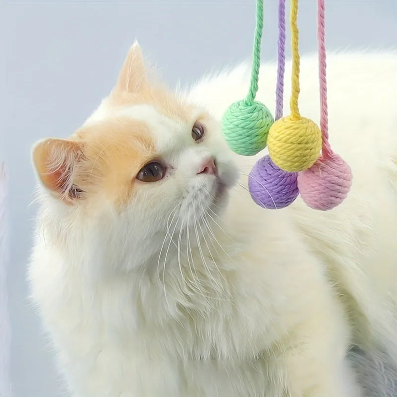 Interactive cat toy ball with bell and rope in green, pink, purple or yellow colours, shown in 3cm and 6cm sizes