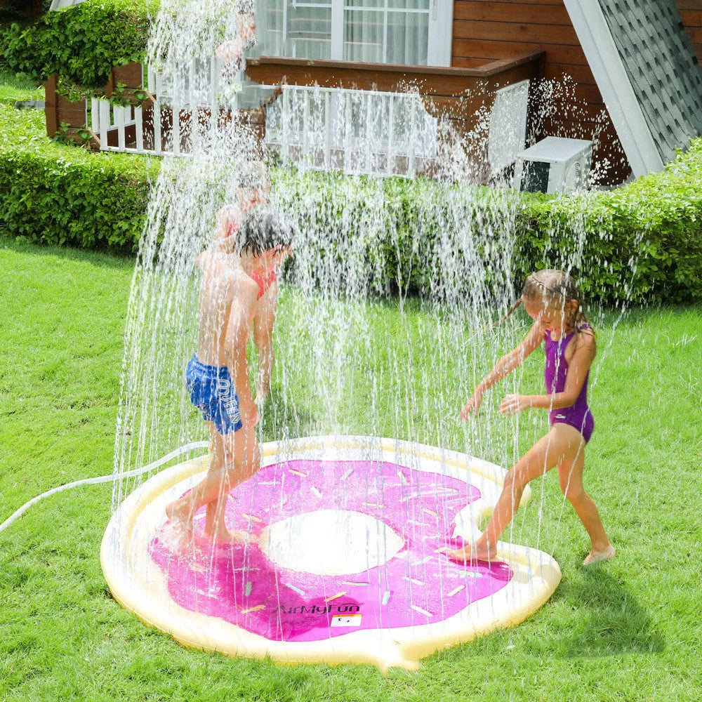 Children playing on a vibrant watermelon design water spray mat outdoors