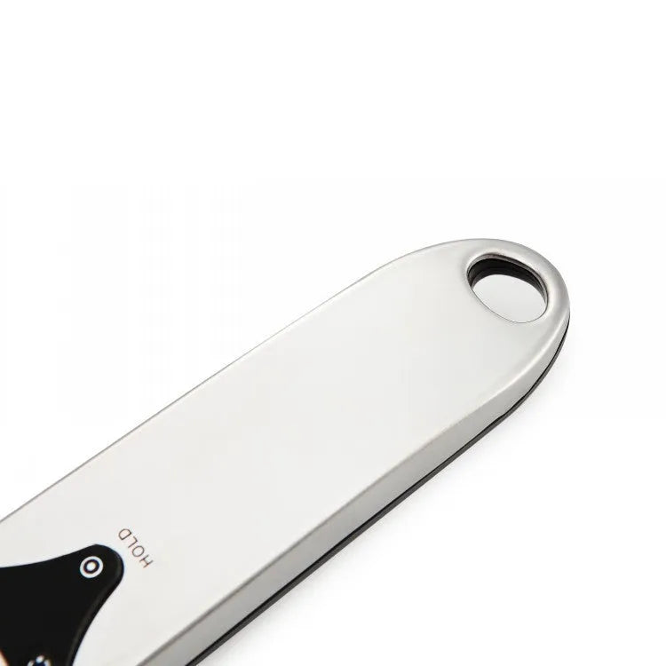 Smart digital measuring spoon with electronic display showing weight, alongside two AAA batteries.