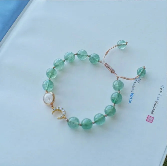 Handcrafted strawberry quartz crystal bracelet with adjustable string closure and Hetian jade peach blossom design