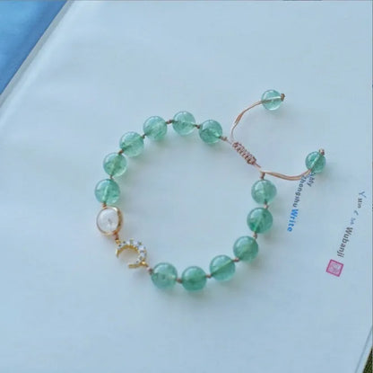 Handcrafted strawberry quartz crystal bracelet with adjustable string closure and Hetian jade peach blossom design