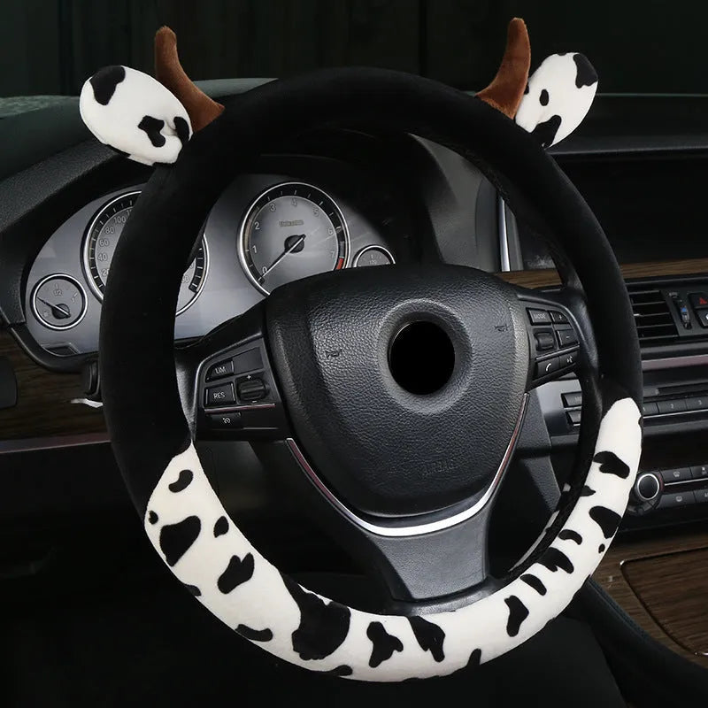 Short plush automotive steering wheel cover in black colour showing soft texture.