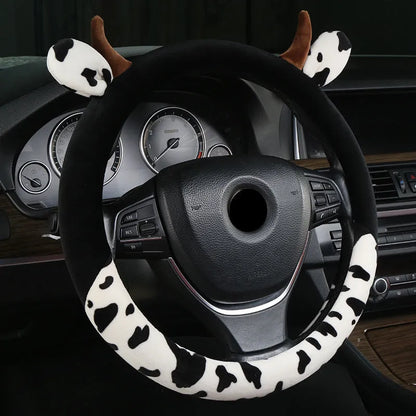 Short plush automotive steering wheel cover in black colour showing soft texture.