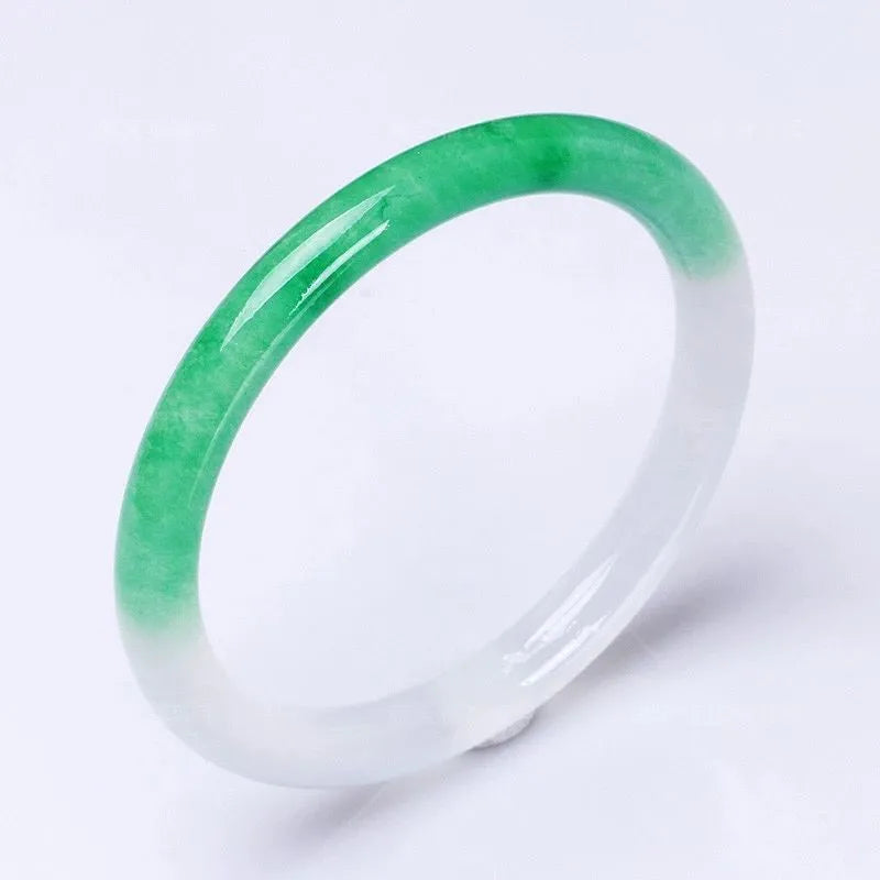 Jade bracelet with floating flower patterns and auspicious cloud motifs in green stone with polished finish