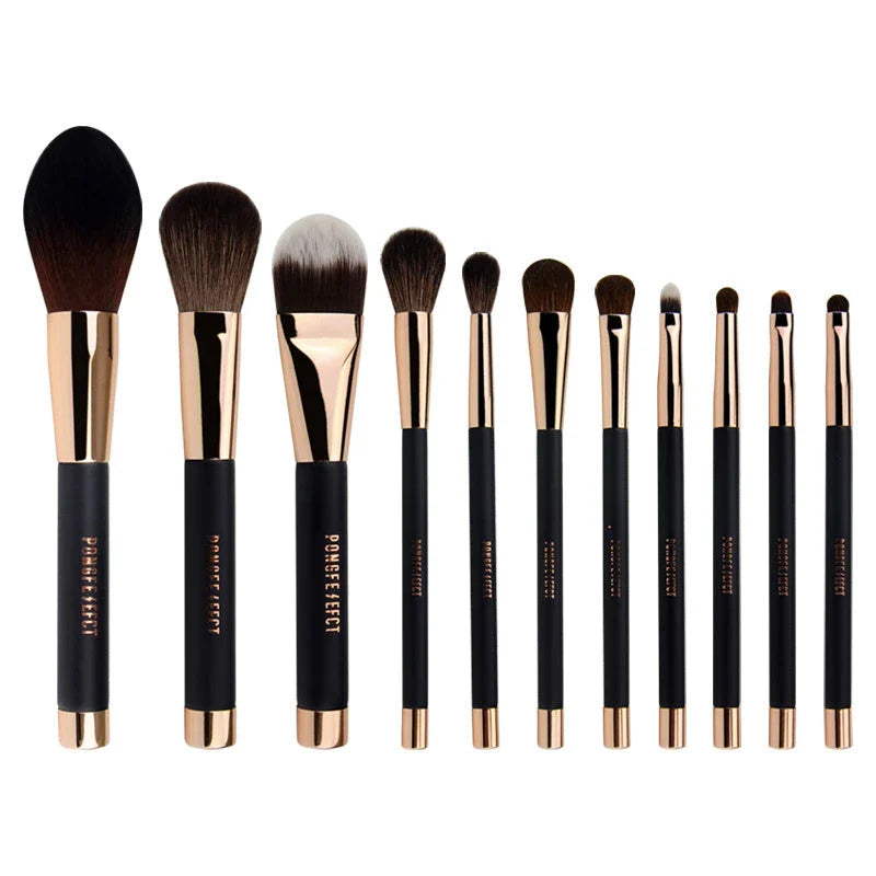 A premium makeup brush set with a sleek black and gold design, featuring 11 essential brushes and a magnetic holder for easy organization.