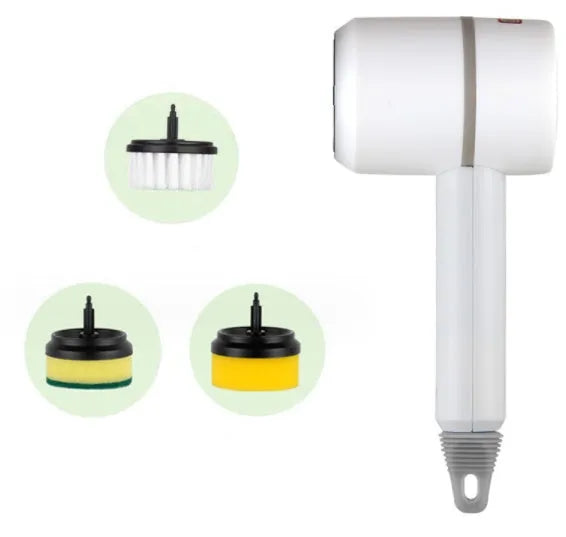 Green electric cleaning brush with scouring pad and brush heads on a kitchen worktop.