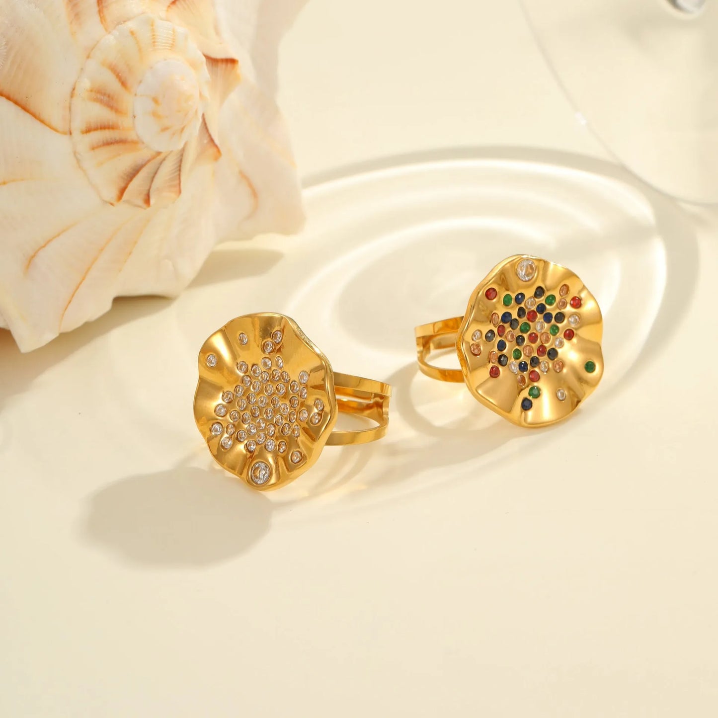 Pleated geometric open mouth ring made from stainless steel with colourful crystal inlay on a hand.