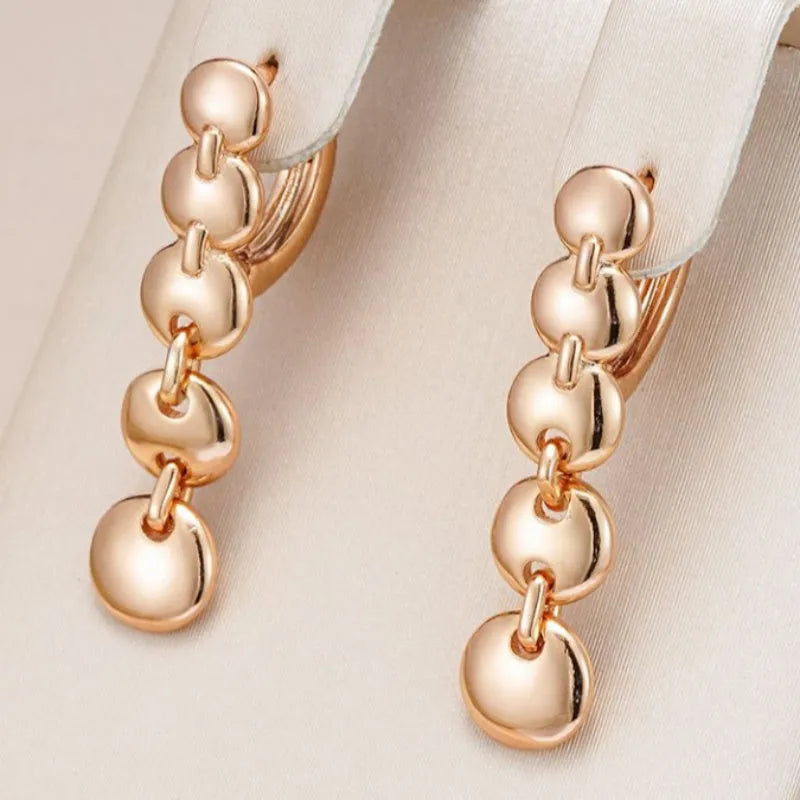 Gold finish hand-woven copper circle earrings showing textured surface and 5cm diameter