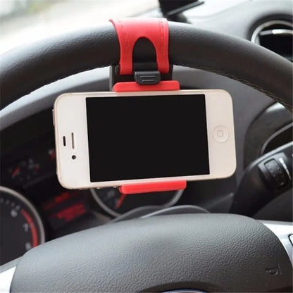 Black steering wheel phone holder with 75mm clip mounted on car wheel holding smartphone