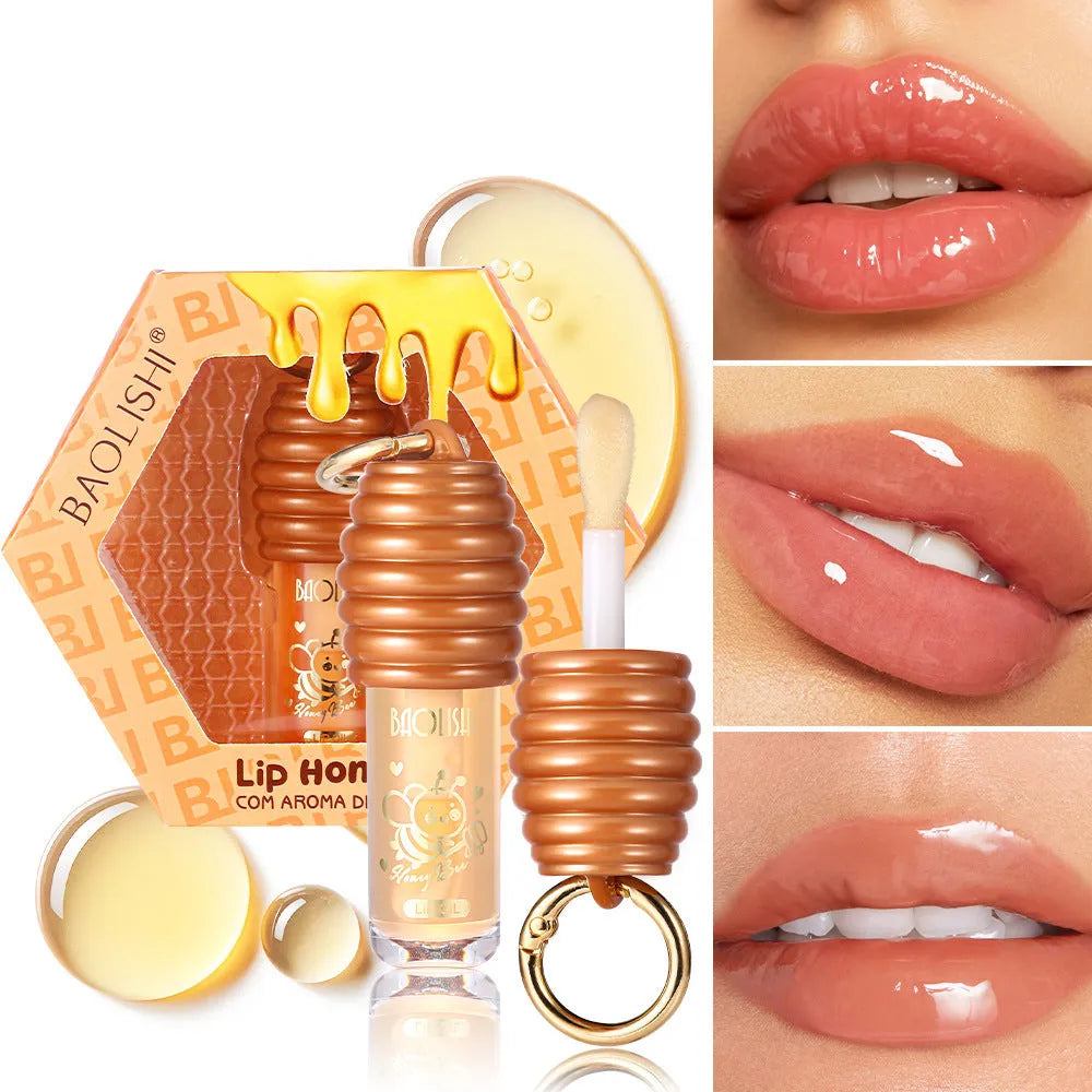 Moisturising honey lip gloss on a silver keychain against a plain background.