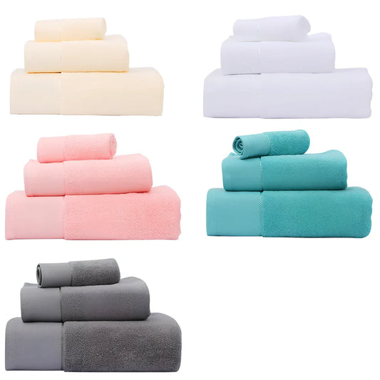 Three-piece cotton towel set showing 70x140cm bath towel, 35x75cm face towel, and 32x32cm square towel with combed yarn texture