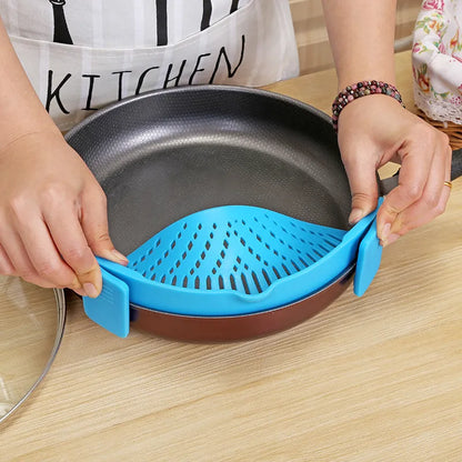 Silicone clip-on kitchen strainer with stainless steel frame attached to pot rim
