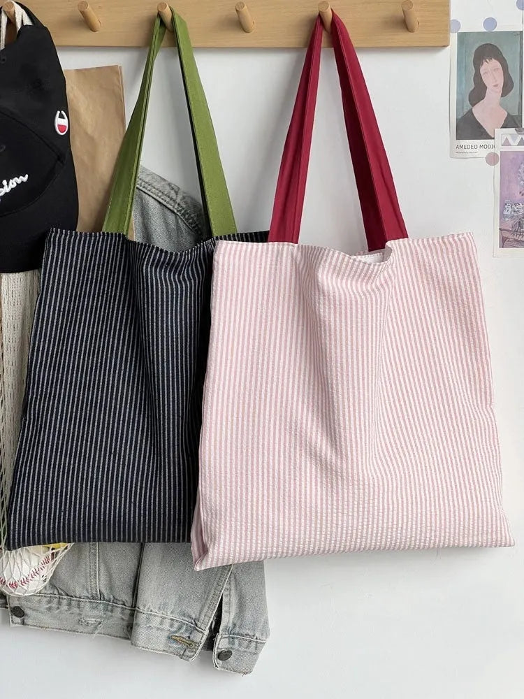 Light pink striped cotton canvas multi-layer tote bag with a wide shoulder strap.