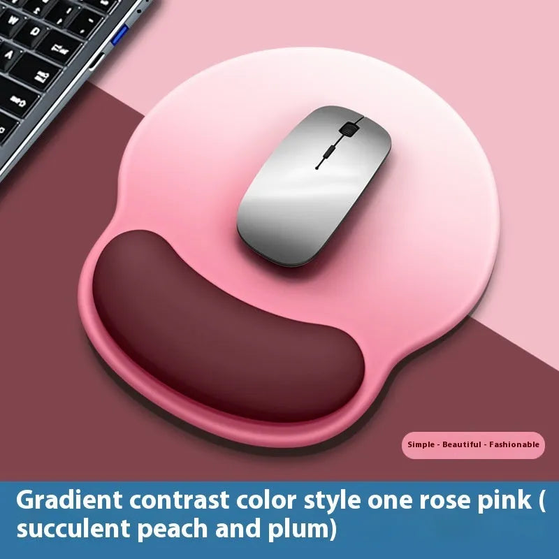 Silicone mouse mat with wristband in a gradient blue black colour pattern on a desk.