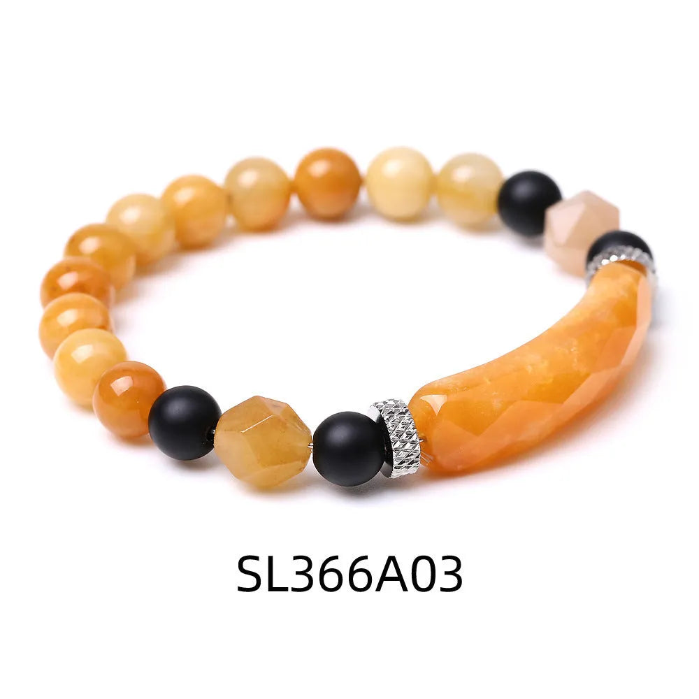 Handmade diamond-shaped cut black agate bracelet with fan-shaped details on a wrist.