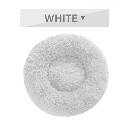 Fluffy donut-shaped dog bed in dark grey colour with raised edges, showing plush texture and circular design