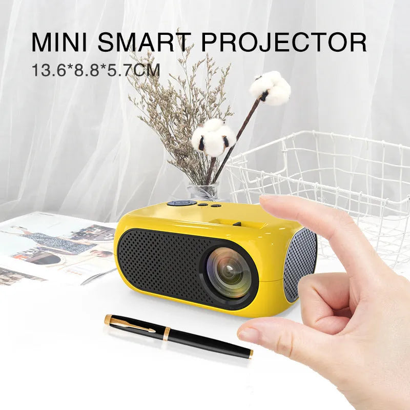 M24 gold and white portable mini LED projector with remote on a wooden table.