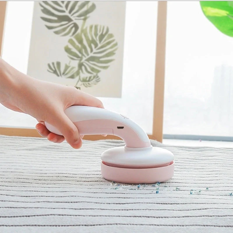 Mini desktop vacuum cleaner in pink, green, blue, and gray for dust removal