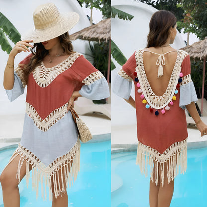 Orange floral pattern beach overskirt with white crochet stitching and long tassels.