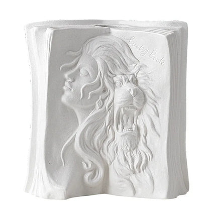 White ceramic book stand holding an open book at an angle, with a wire page holder in use.