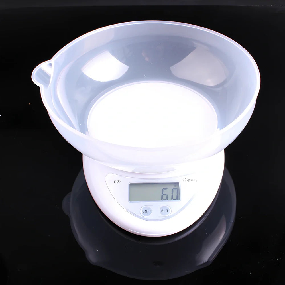 White electronic kitchen scale with digital display showing 1g precision and 5kg capacity measurements