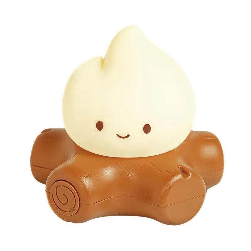 Small silicone fire pile-shaped night lamp with a cartoon ABS shade showing yellow light illumination.