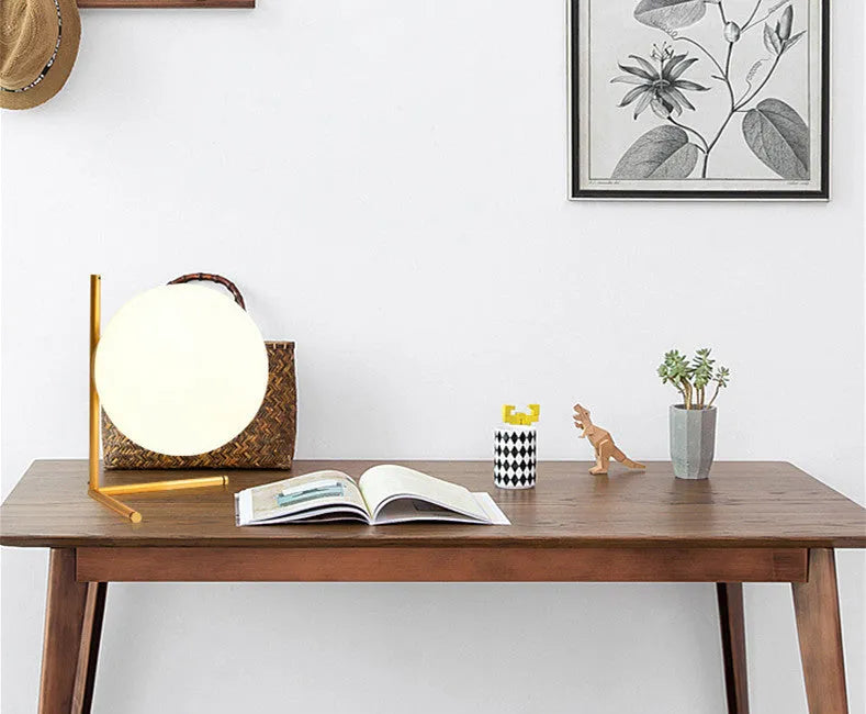 Creative glass table lamp with LED light in one of three available sizes for a living room or study