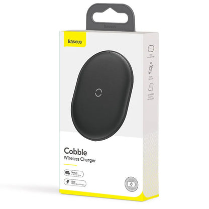 Black Baseus 15W wireless charging pad with textured silicone surface on a wooden desk.