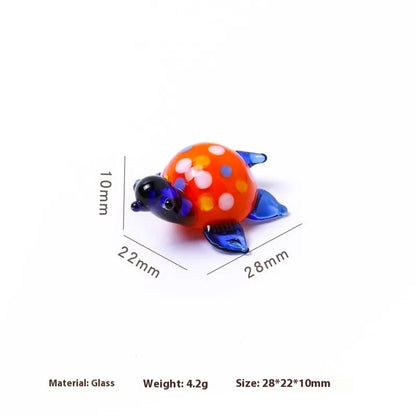 Geometric glass turtle figurine ornament on a desk, shown in blue head and blue shell colour variant.