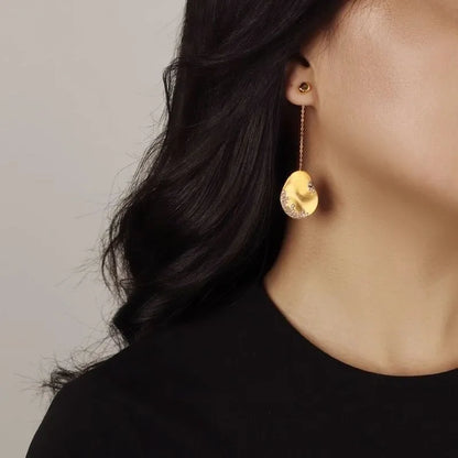 Asymmetric floral drop earrings with gold plating and zircon stone accents in silver colour