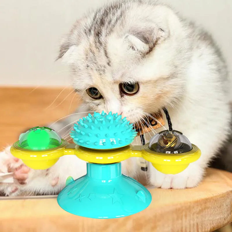 Cat rotating windmill toy with suction base, two transparent bins, blue and yellow-green TPR body.