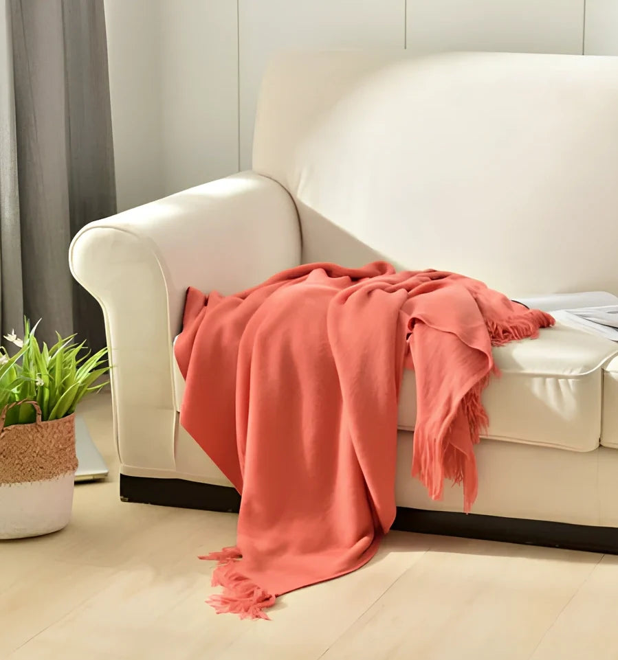 130x150cm knitted acrylic blanket with 10cm fringe detailing in beige colour draped over sofa