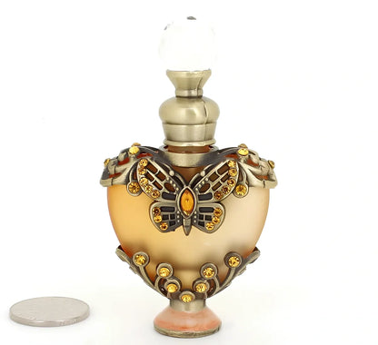 Heart-shaped refillable perfume bottle with metal and crystal construction, 3.6 inches tall