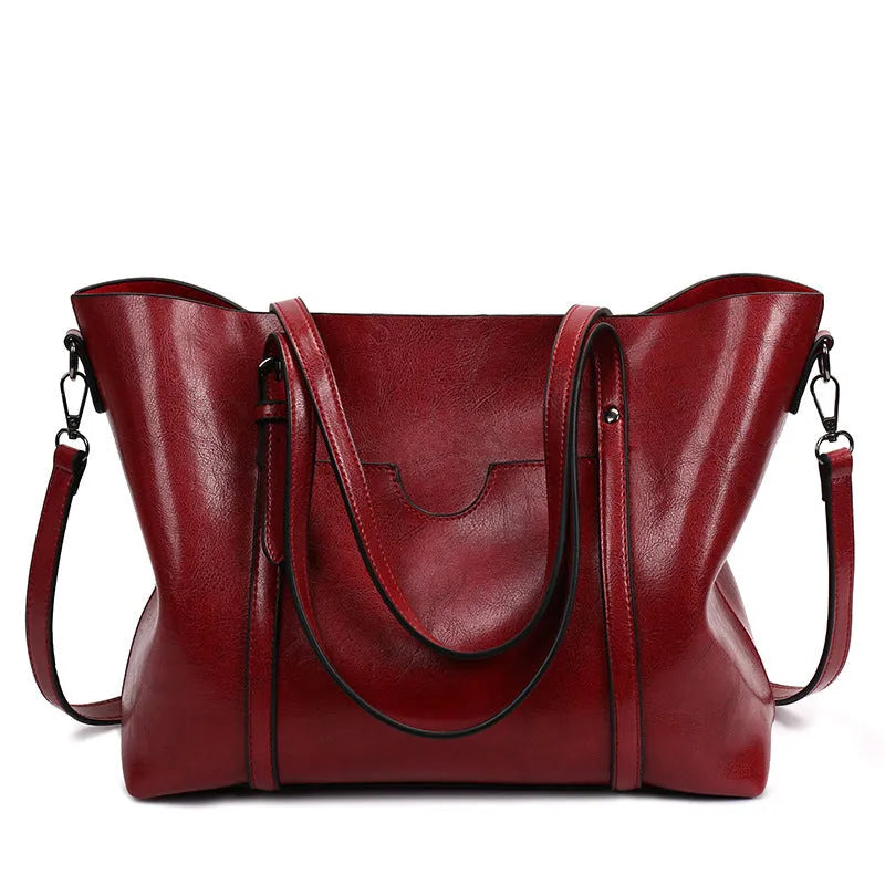 Retro messenger bag showing 31cm length, A4 magazine capacity, available in eight colours including wine red and light blue